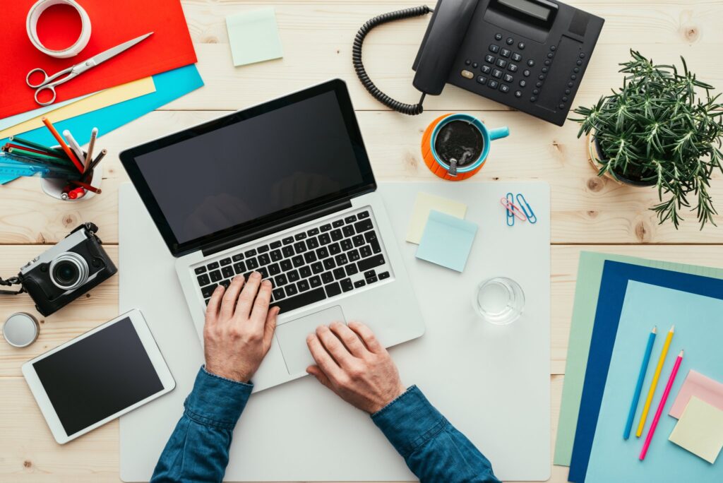 a person working on a laptop on a desk